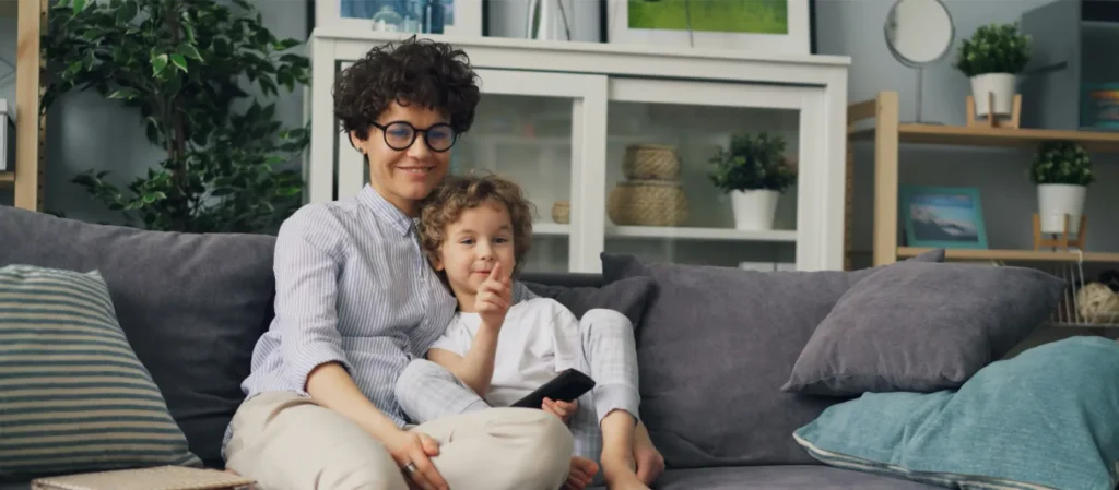 Parent and child sitting comfortably on a couch