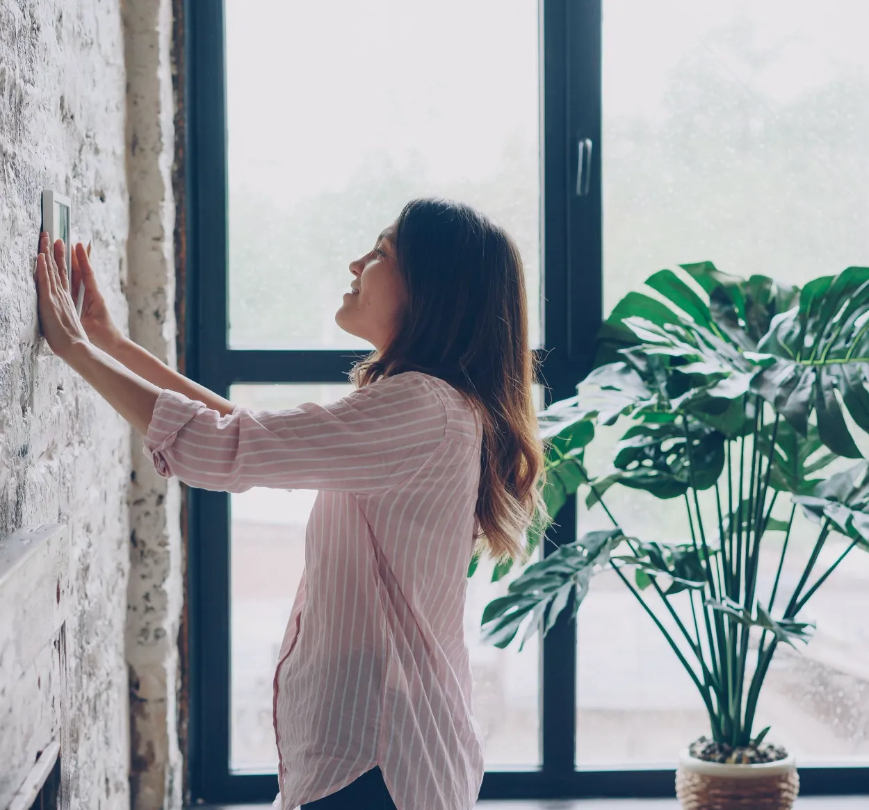 Woman adjusting A/C temperature